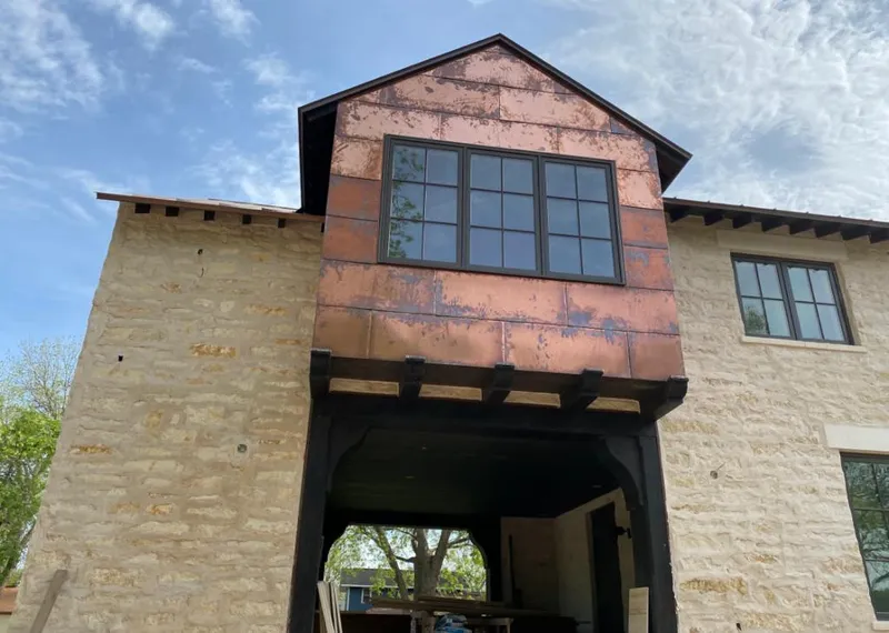 Copper metal panel facade on a stone building for Metal Roof Coating in Collier