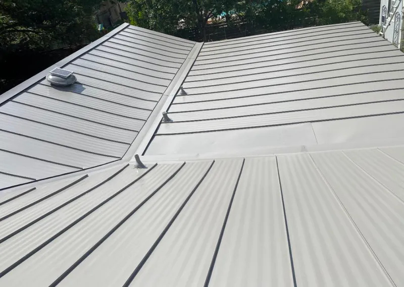 Solar attic fan installed on a metal roof for Roof Ventilation in Collier